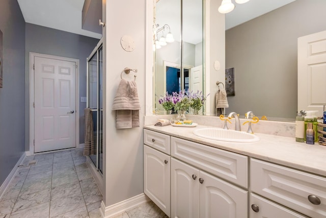 bathroom featuring vanity and an enclosed shower