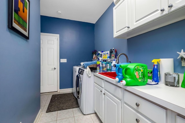 laundry room featuring cabinets, sink, light tile patterned floors, and washer and dryer