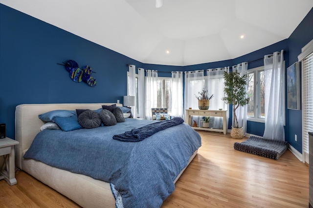 bedroom with hardwood / wood-style floors and vaulted ceiling