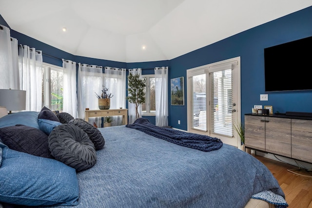 bedroom with wood-type flooring and lofted ceiling