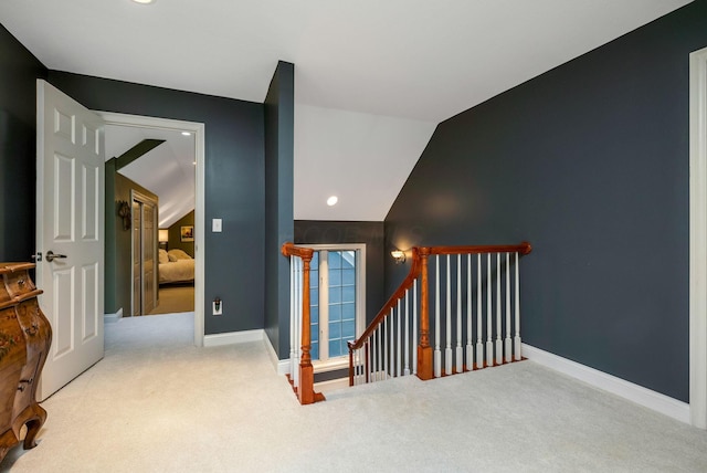 stairway featuring carpet flooring and lofted ceiling