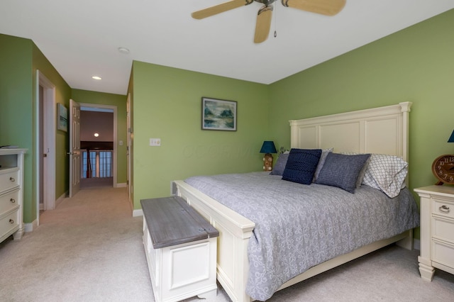 bedroom with ceiling fan and light colored carpet