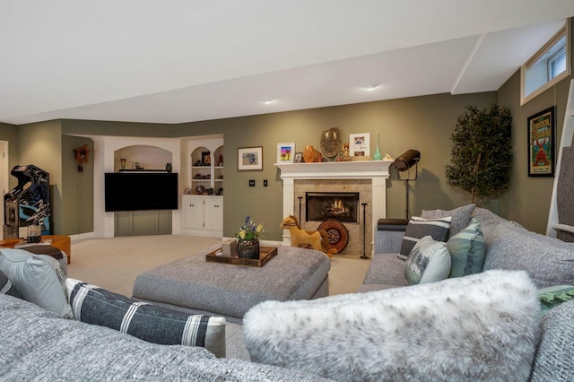 carpeted living room featuring a fireplace and built in features