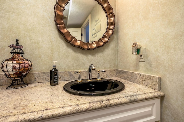 bathroom with a textured ceiling and vanity