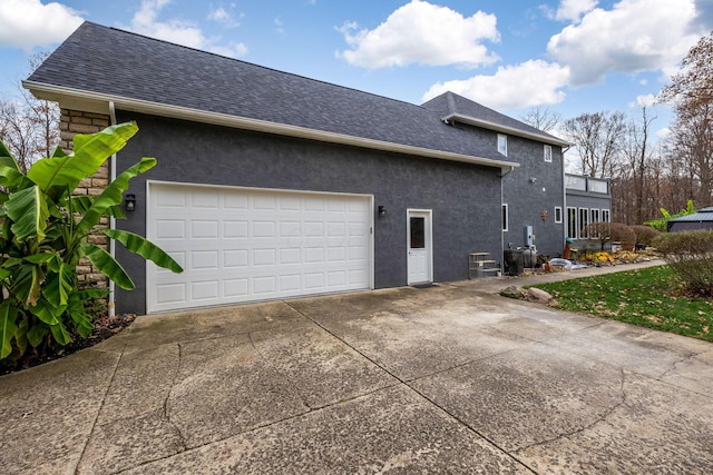 view of property exterior featuring a garage and central air condition unit