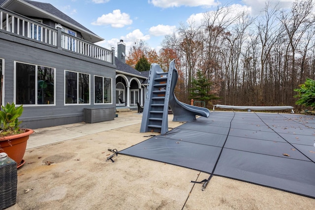 exterior space featuring a patio area and a water slide