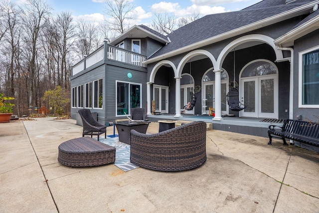 view of patio featuring outdoor lounge area, a balcony, and french doors