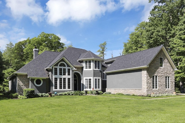 6003 Nichols Ln, Johnstown, OH 43031 - view of front of home featuring stone siding, a front lawn, and a chimney