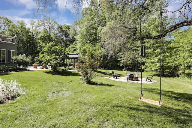 6003 Nichols Ln, Johnstown, OH 43031 - view of grassy yard with a fire pit and a patio area