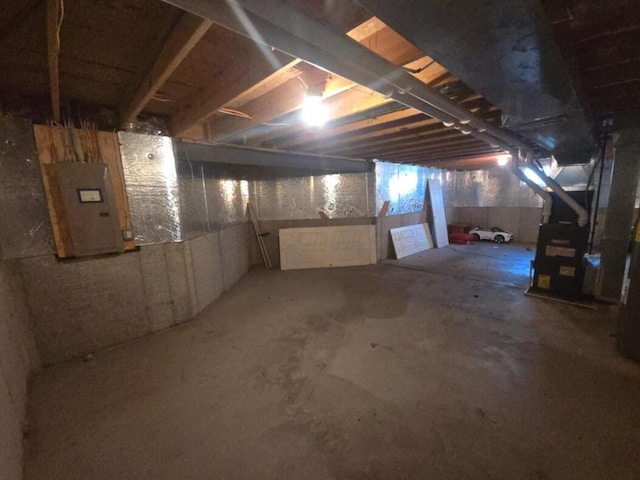 basement with electric panel and heating unit