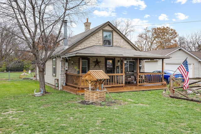 view of front of property with a front yard, a garage, and covered porch