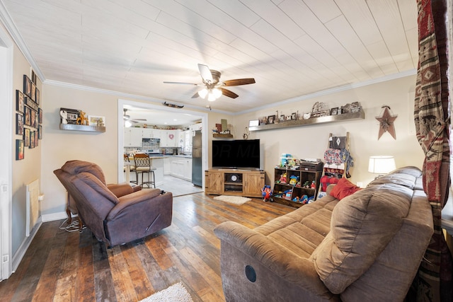 living room featuring wood-type flooring, ceiling fan, and ornamental molding