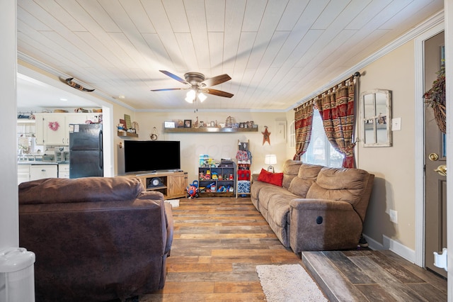 living room with ceiling fan, wood-type flooring, crown molding, and wooden ceiling