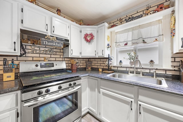 kitchen featuring white cabinetry, stainless steel range with gas cooktop, sink, and tasteful backsplash