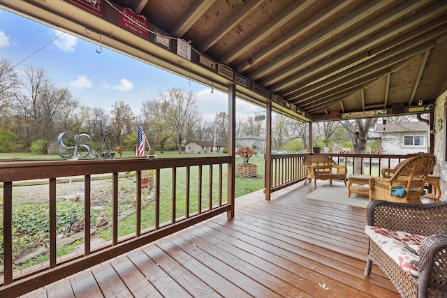 wooden deck featuring a yard