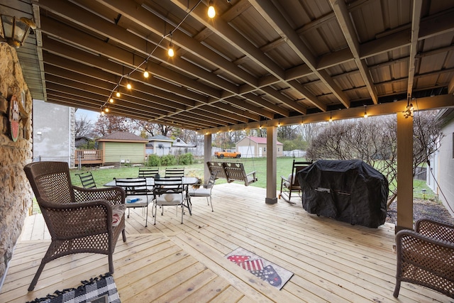 deck with a grill and a yard