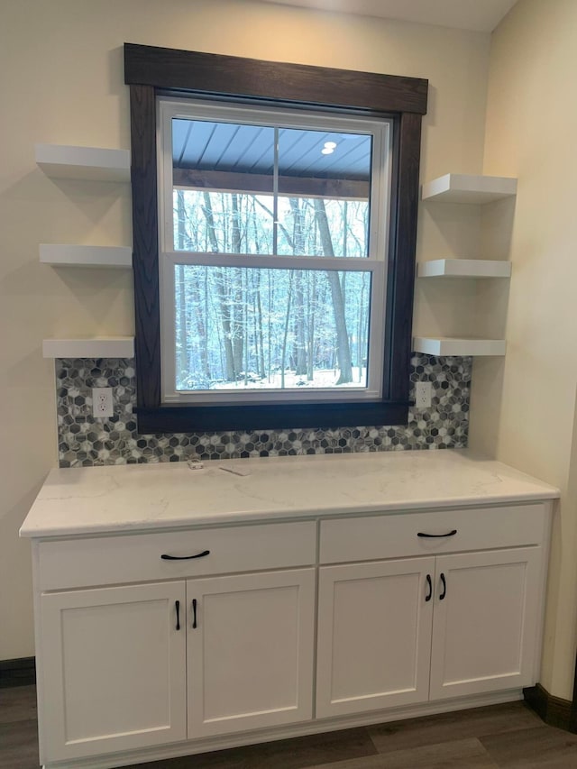 interior details with hardwood / wood-style floors and tasteful backsplash