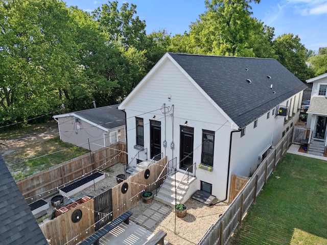 rear view of property with a yard