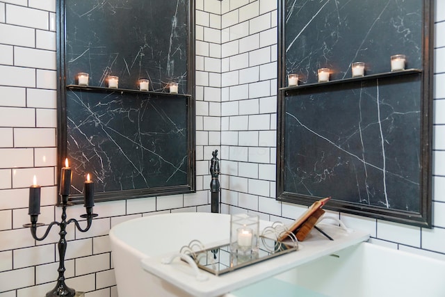 bathroom with tile walls and a bathing tub