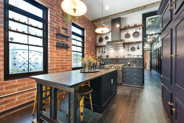 kitchen featuring island exhaust hood, sink, brick wall, and dark hardwood / wood-style floors