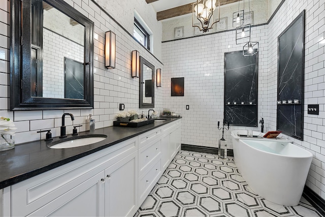 bathroom with backsplash, vanity, a bathtub, and tile walls