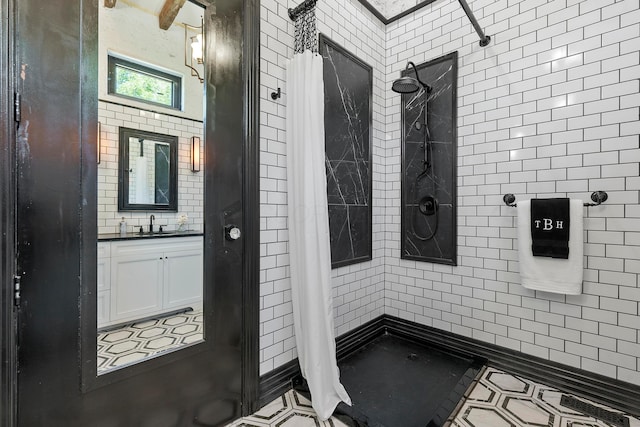 bathroom featuring a shower with shower curtain, vanity, and tile patterned floors