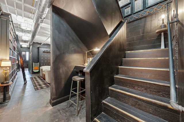 staircase with concrete flooring