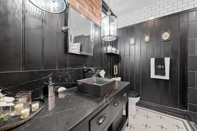 bathroom with backsplash, tile patterned floors, vanity, and toilet