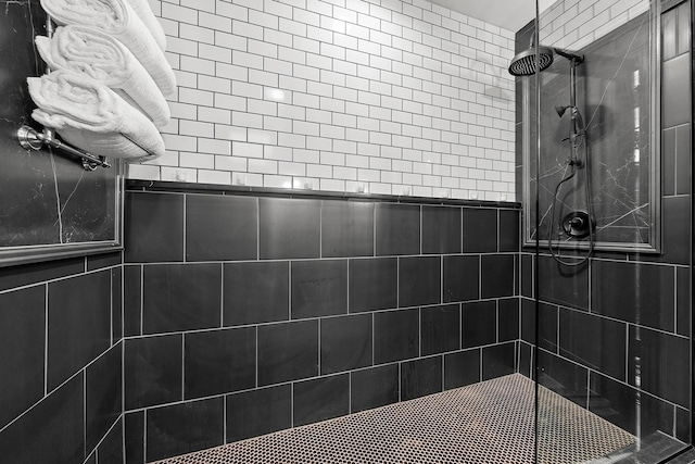 bathroom with a tile shower