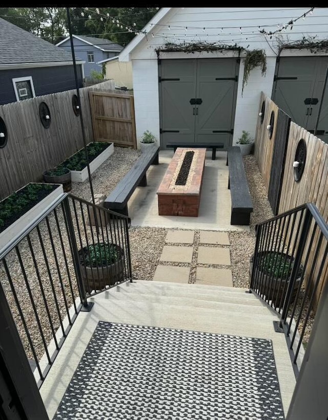 view of patio featuring a storage unit