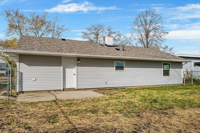 rear view of property with a lawn