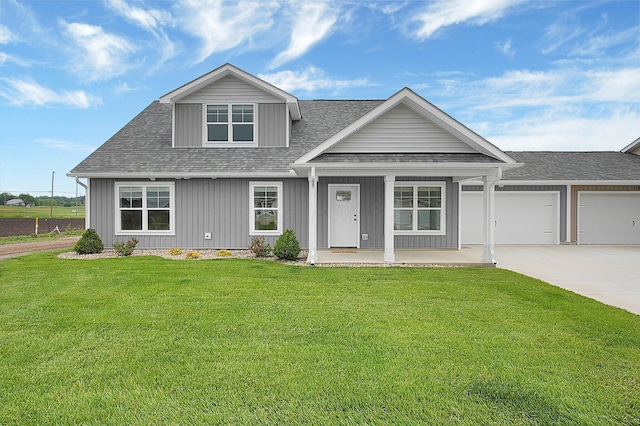 110 Cumberland Meadows Cir, Hebron, OH 43025 - view of front of property featuring driveway, a shingled roof, covered porch, a front lawn, and an attached garage