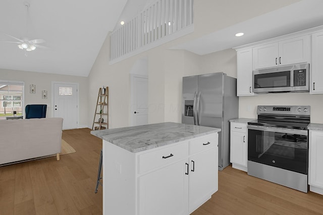 110 Cumberland Meadows Cir, Hebron, OH 43025 - kitchen featuring appliances with stainless steel finishes, open floor plan, ceiling fan, high vaulted ceiling, and light wood finished floors