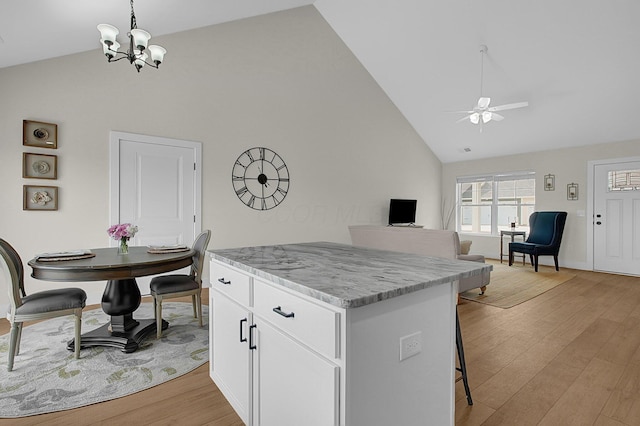 110 Cumberland Meadows Cir, Hebron, OH 43025 - kitchen featuring high vaulted ceiling, ceiling fan, a kitchen island, light wood-type flooring, and a chandelier