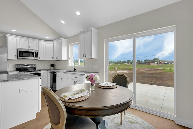 110 Cumberland Meadows Cir, Hebron, OH 43025 - kitchen with appliances with stainless steel finishes, a sink, white cabinetry, lofted ceiling, and light wood-style flooring