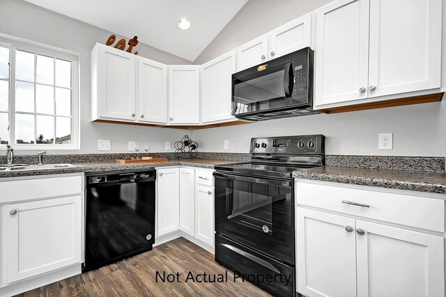 kitchen featuring sink, white cabinets, black appliances, and lofted ceiling