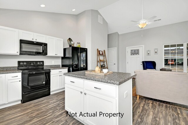 kitchen with black appliances, white cabinetry, and a kitchen island