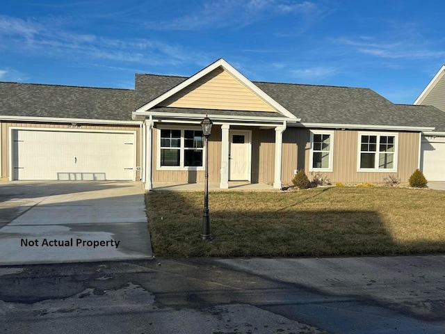 view of front facade with a front yard and a garage