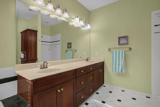 bathroom with tile patterned floors, vanity, and walk in shower