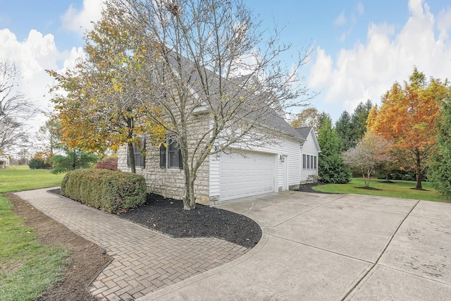 view of property exterior featuring a yard and a garage