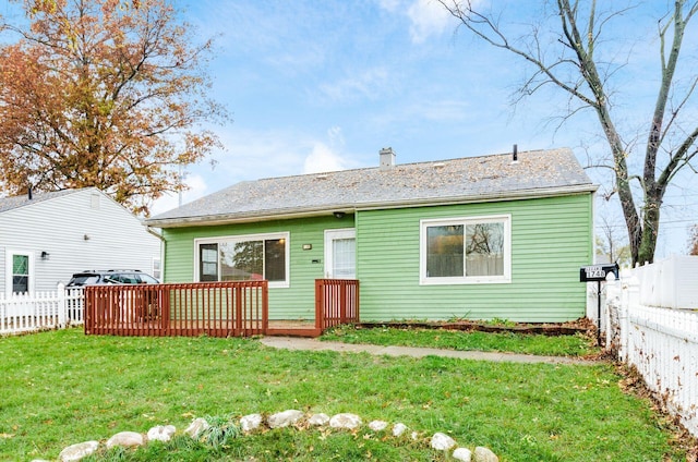 view of front of home with a front yard and a deck