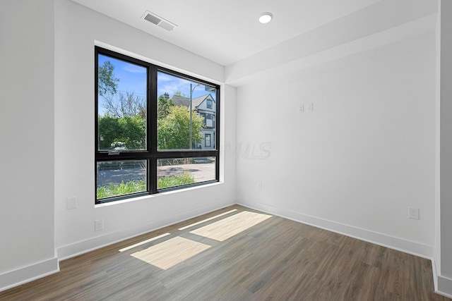 unfurnished room with dark hardwood / wood-style flooring