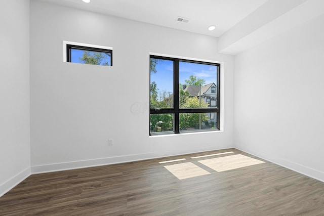 unfurnished room featuring dark wood-type flooring