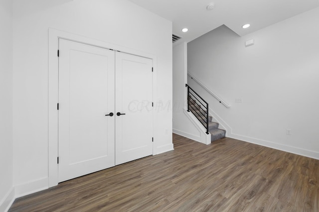 interior space featuring a closet and dark hardwood / wood-style floors