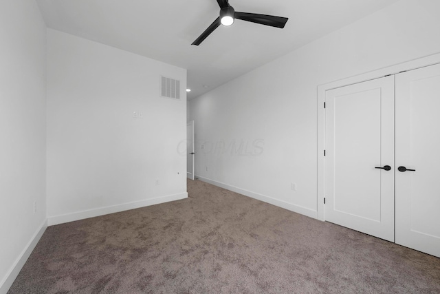 unfurnished bedroom featuring a closet, ceiling fan, and carpet