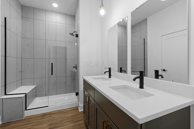 bathroom with vanity, wood-type flooring, and an enclosed shower