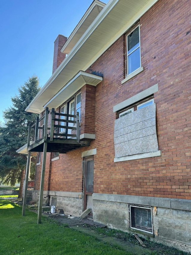 view of side of home featuring a balcony