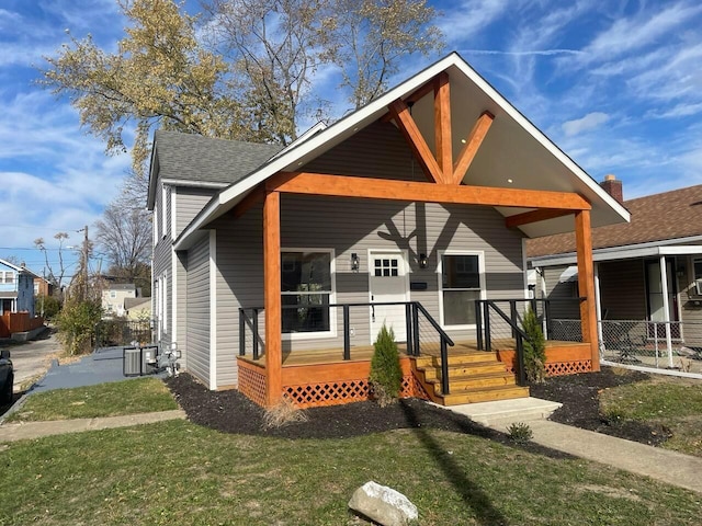 bungalow-style home featuring central AC and a front yard