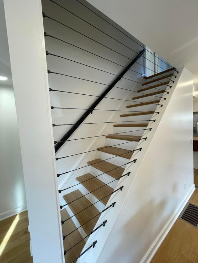 stairs featuring wood-type flooring