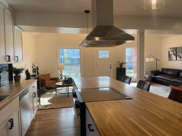 kitchen featuring range with electric cooktop, ventilation hood, butcher block countertops, and stainless steel dishwasher